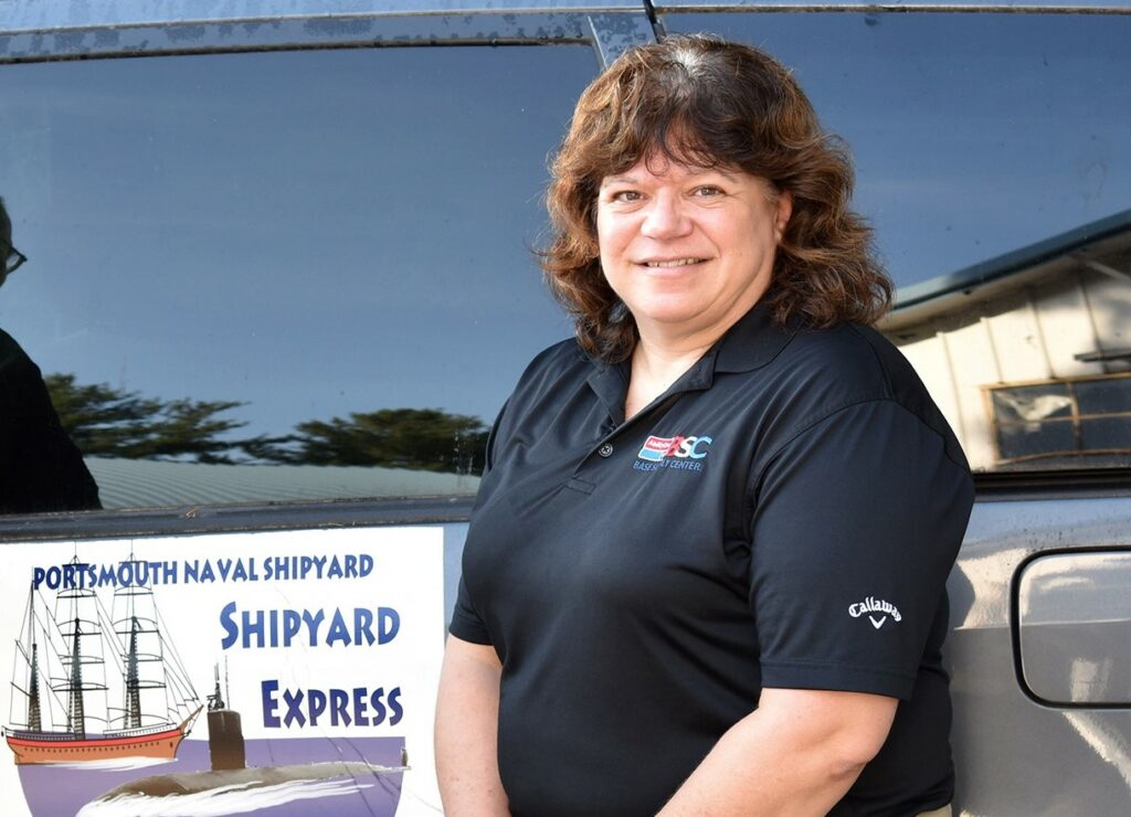 Terri Fabrizio standing in front of a van