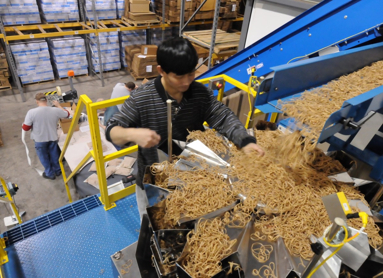 An employee using the rubberband machine.